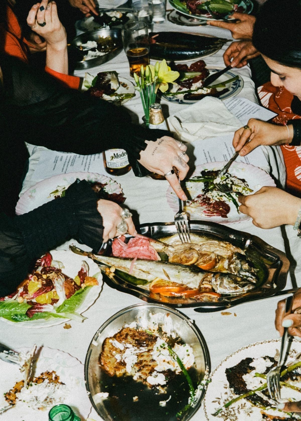 Guests sharing dinner plates around a table