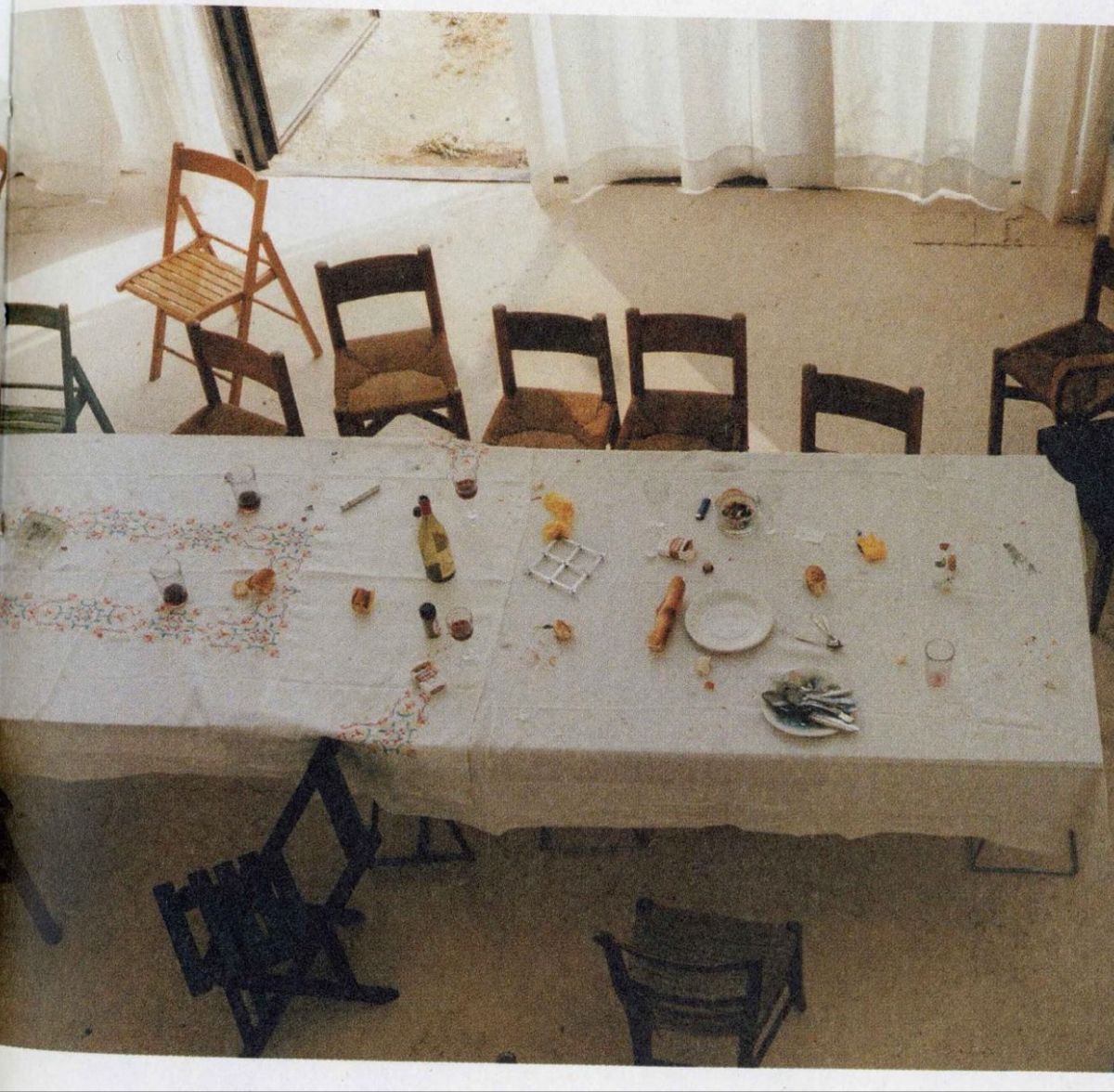 A long supper club table set with chairs before guests arrive