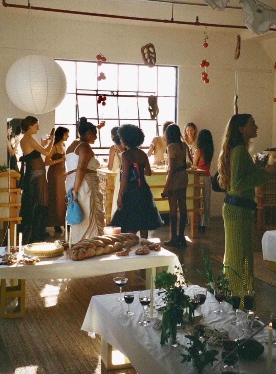 Guests mingling in a creative supper club space